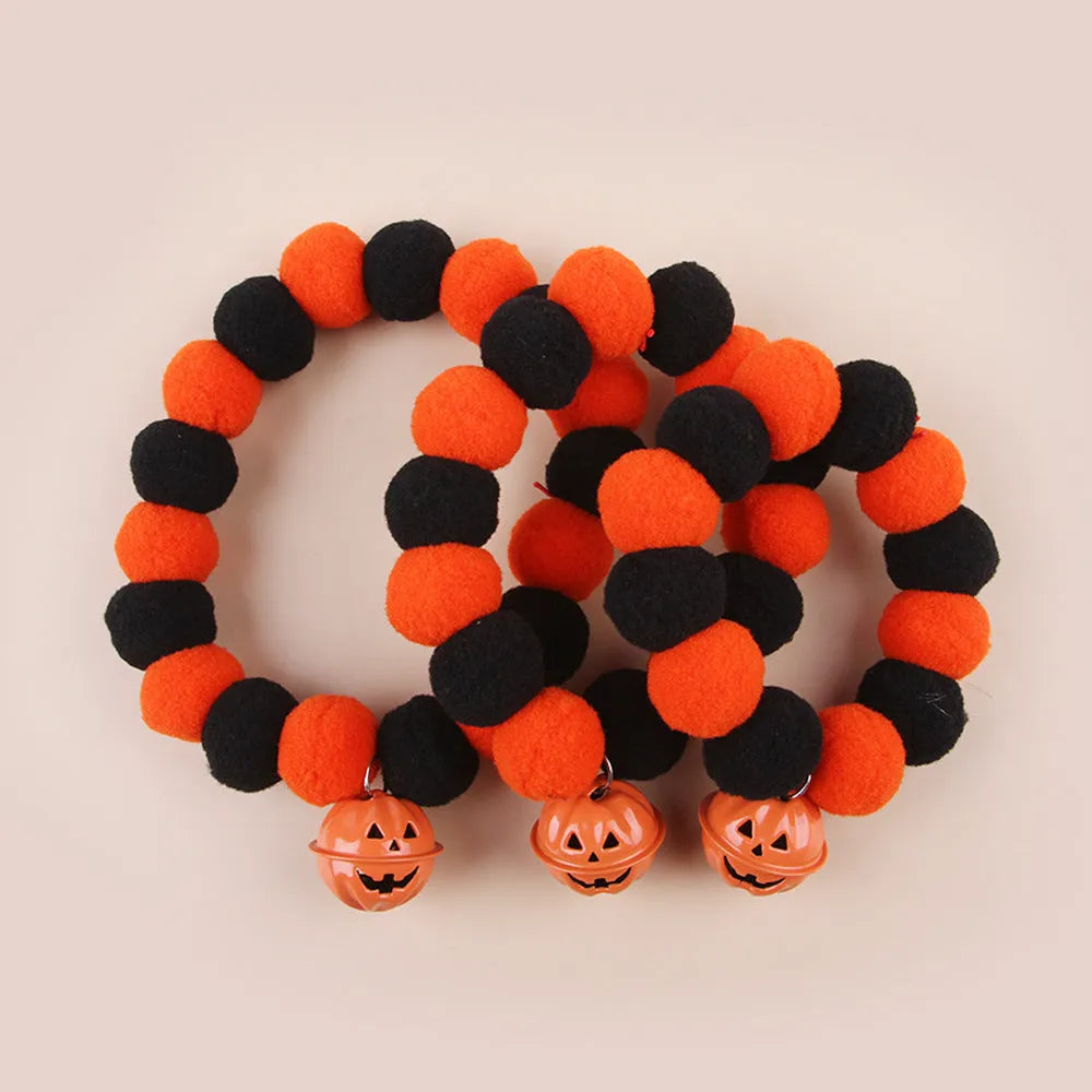 Adjustable orange plastic cat collar with a detailed Halloween pumpkin decoration.