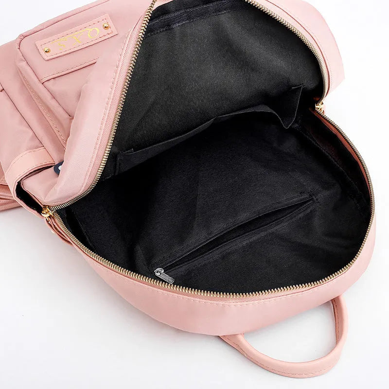 Men's black casual nylon backpack with shoulder straps, showing outer pocket and square vertical shape.