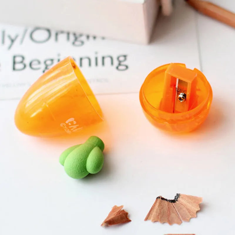 Orange carrot-shaped plastic pencil sharpener with cartoon design showing 7cm handle length