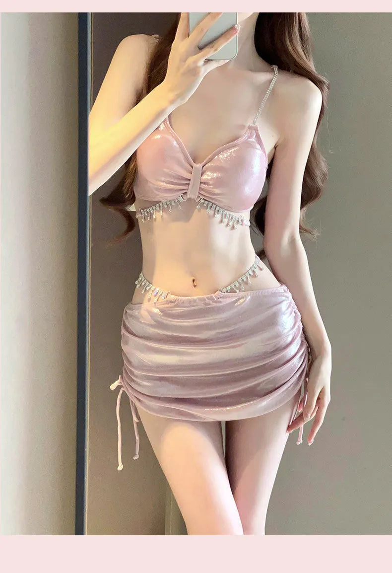 Women's solid pink and black polyester bikini swimsuit laid flat, showing top and bottom pieces.