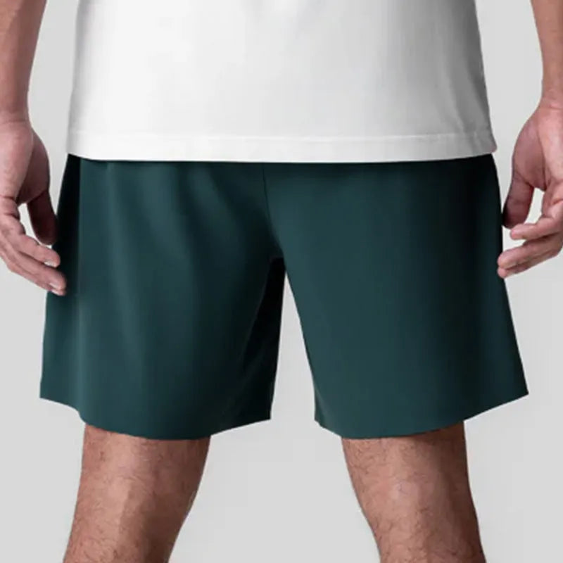 Men's grey seamless sports shorts with knee-length straight-leg cut on a plain background