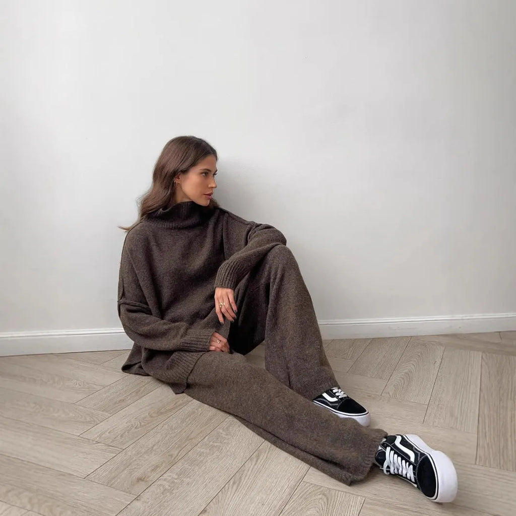 Women's dark grey acrylic suit featuring a side-slit sweater with matching full-length trousers.