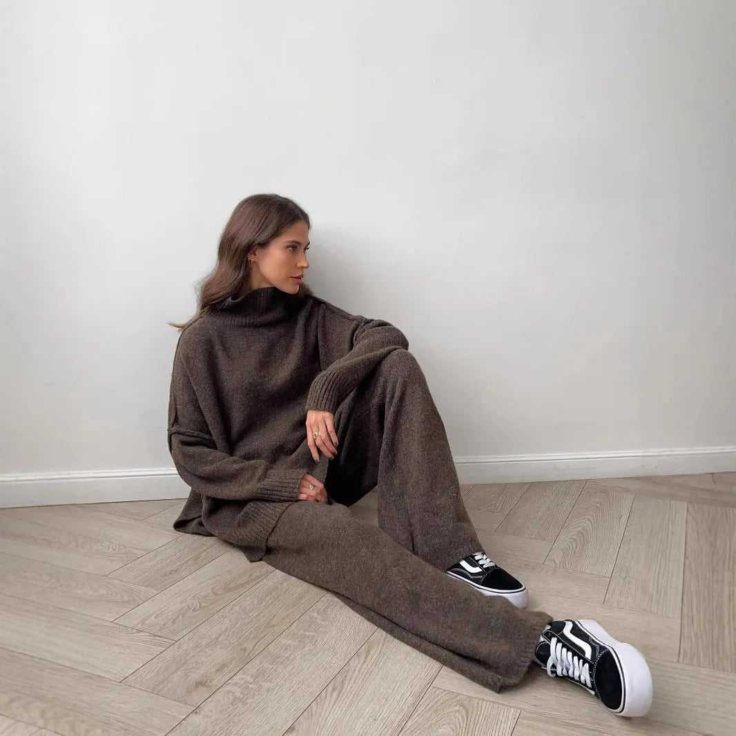 Women's dark grey acrylic suit featuring a side-slit sweater with matching full-length trousers.
