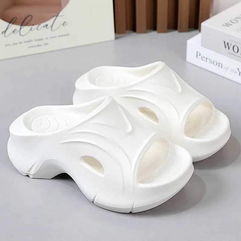 Women's white thick-soled EVA slippers with round toe for beach wear.