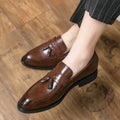 Men's black slip-on business casual shoes with a tassel detail on the front.