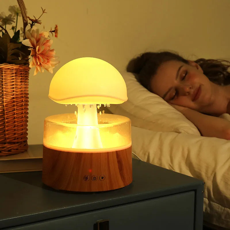 White cloud-shaped humidifier with simulated falling raindrops and coloured LED lighting