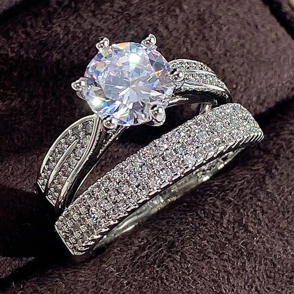 White gold colour alloy geometric wedding ring bracelet with round detail on a hand.