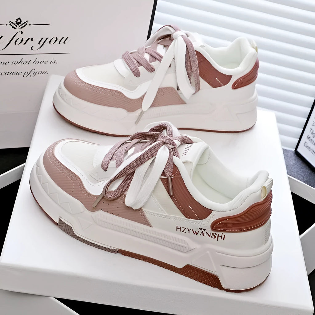 Children's beige board shoes with cross straps, thick rubber sole, and lace-up front.