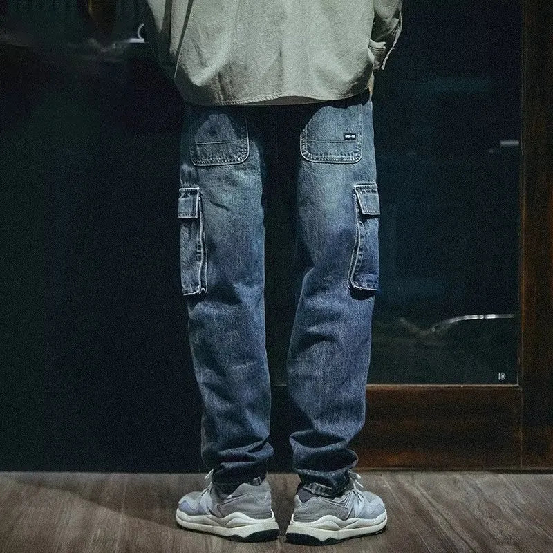 Man wearing blue loose straight leg stretch jeans in a casual setting