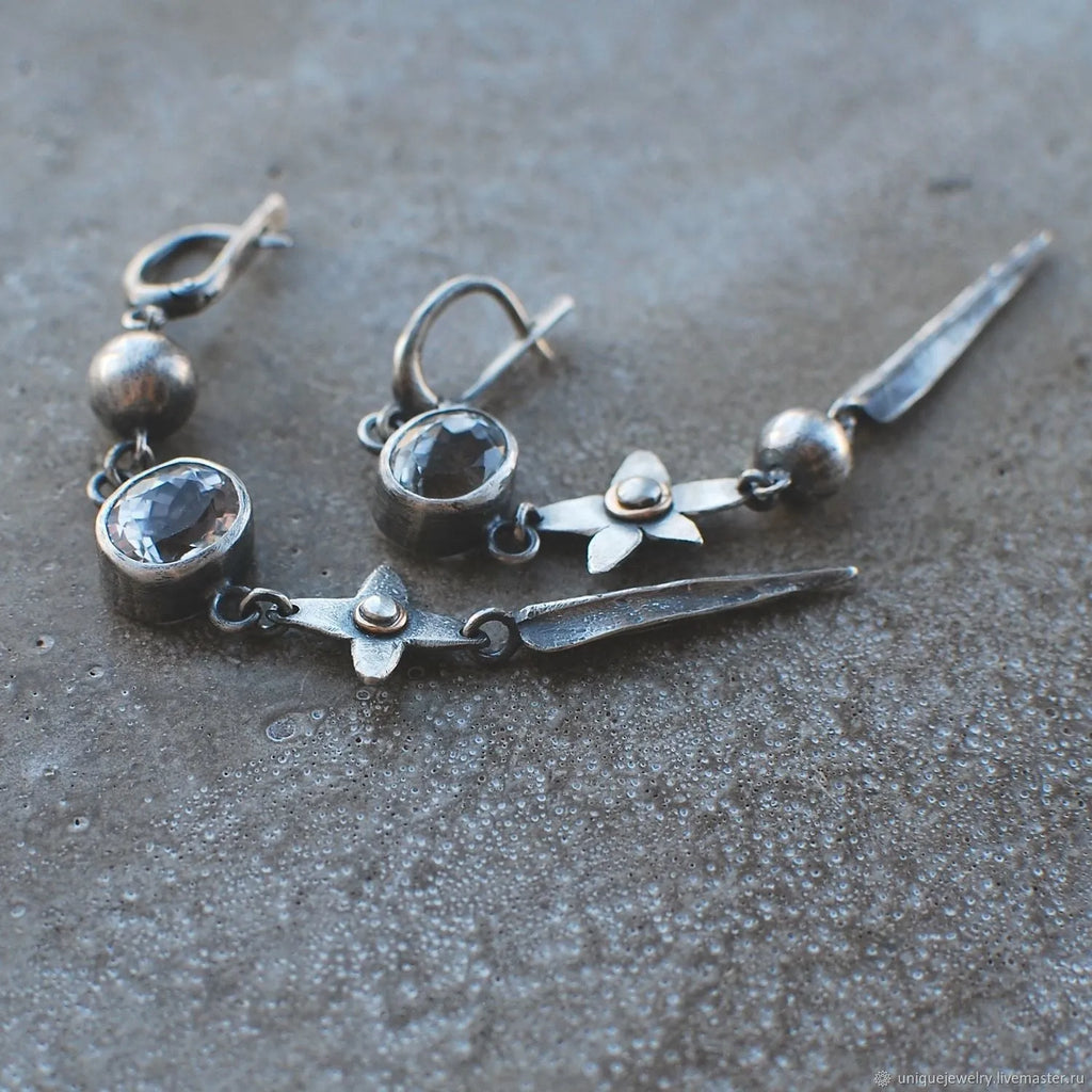 Geometric long XINGX pendant earrings in antique silver with rhinestone details on alloy.
