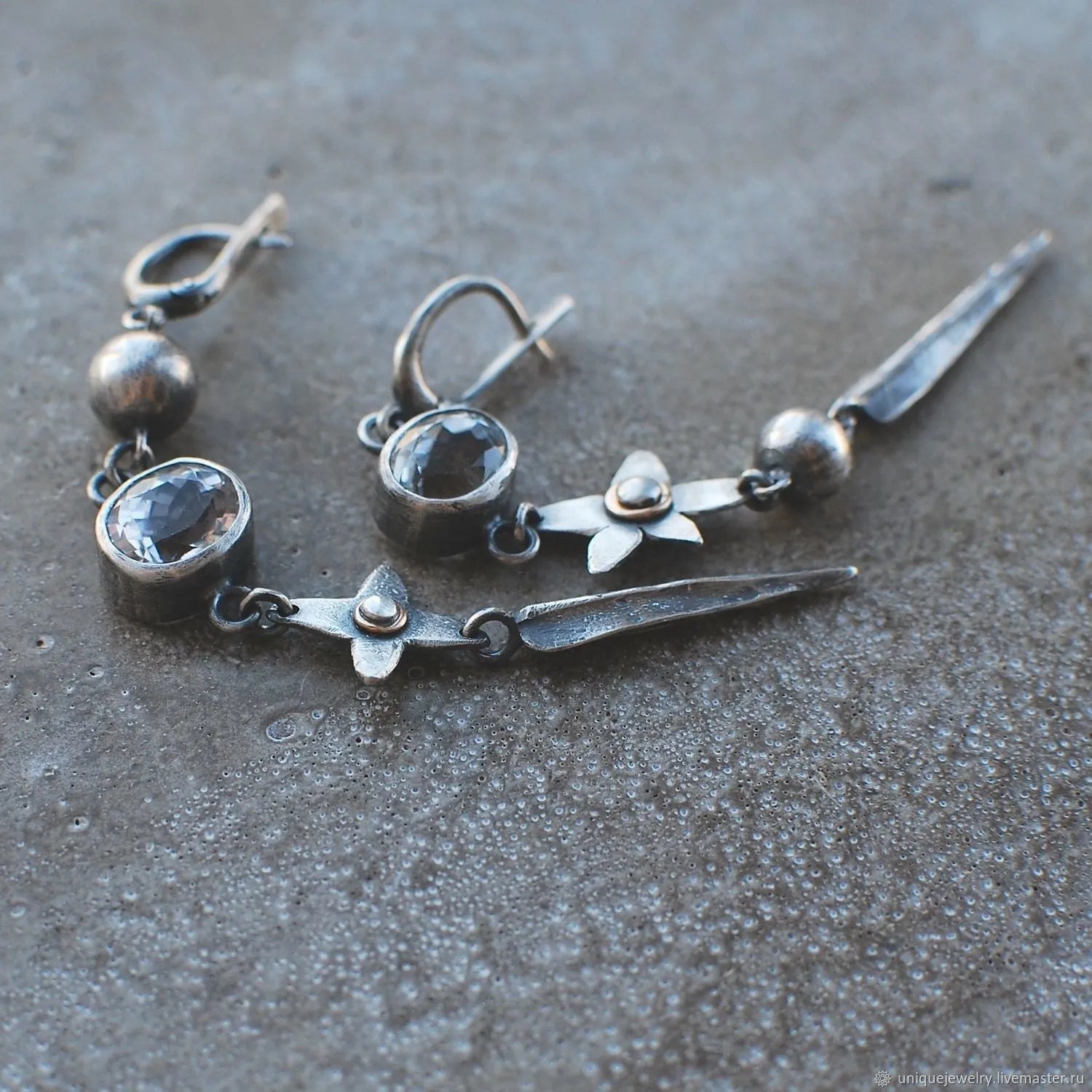 Geometric long XINGX pendant earrings in antique silver with rhinestone details on alloy.