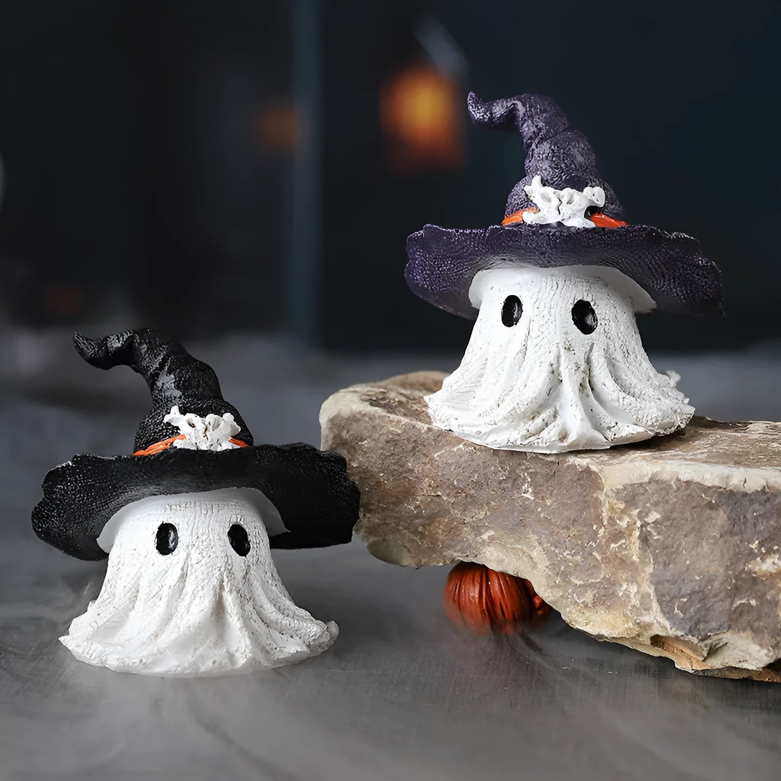 Purple and black resin wizard hat Halloween ghost ornament for holiday decorating.