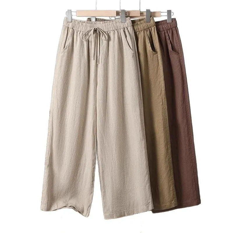 Women's apricot straight-leg casual trousers with elastic waist and drawstring detail laid flat
