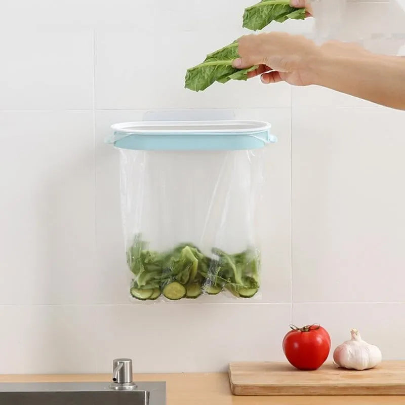 Blue plastic kitchen garbage bag storage rack mounted on wall