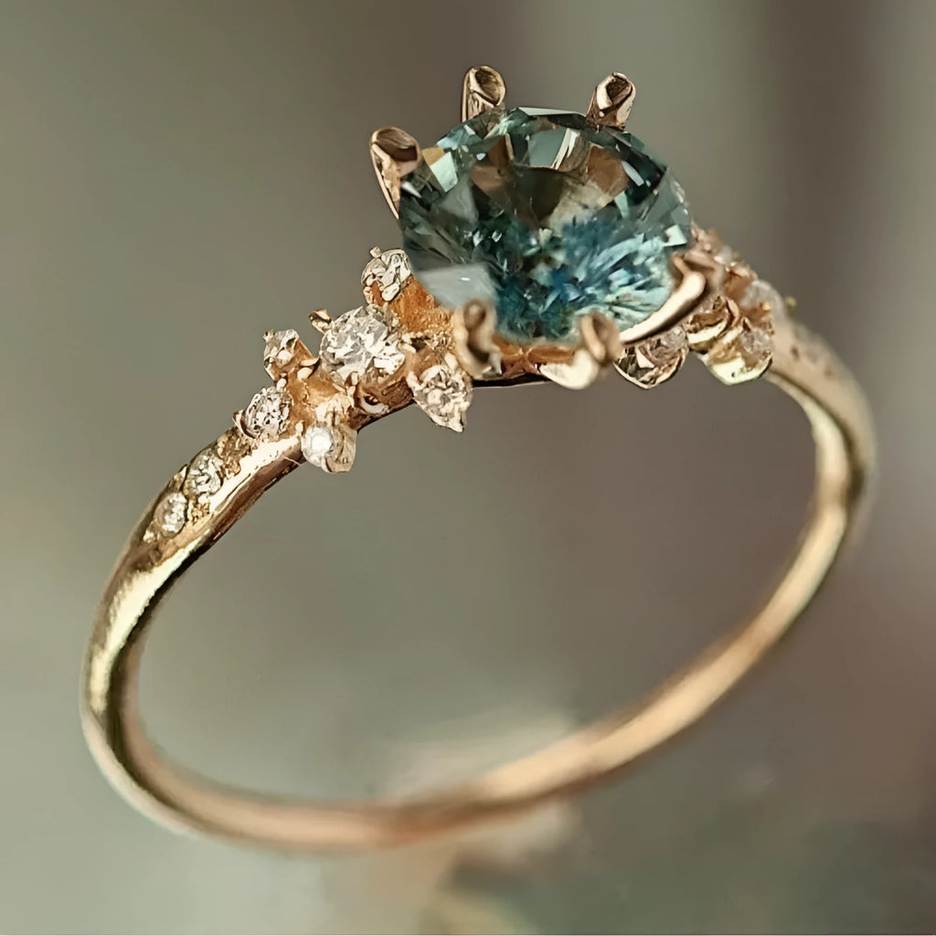 Gold coloured geometric ring with a claw-set zircon stone and chamfered square pattern.