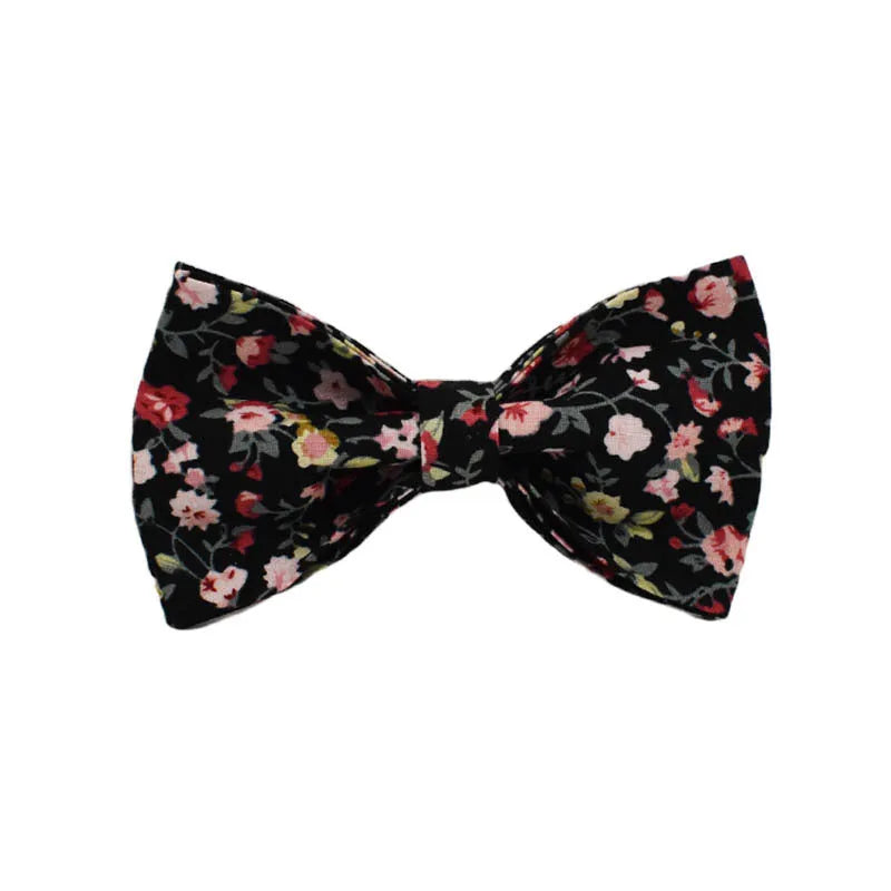 A cloth dog collar set with a removable bow, matching leash, and vest, featuring printed lettering.