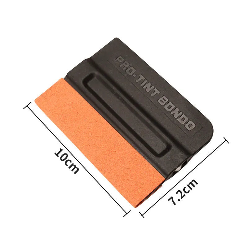 Car film application scraper tool with magnetic head and ABS handle on a work surface.