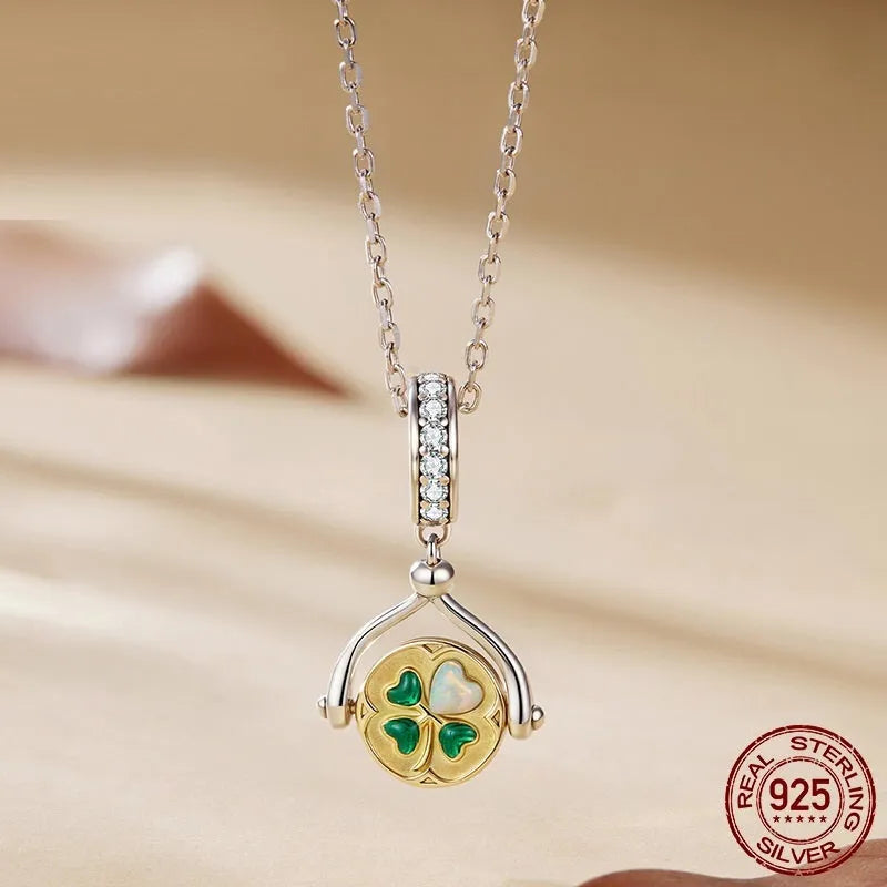 925 silver rotating card pendant with four-leaf clover pattern and wing element on white background
