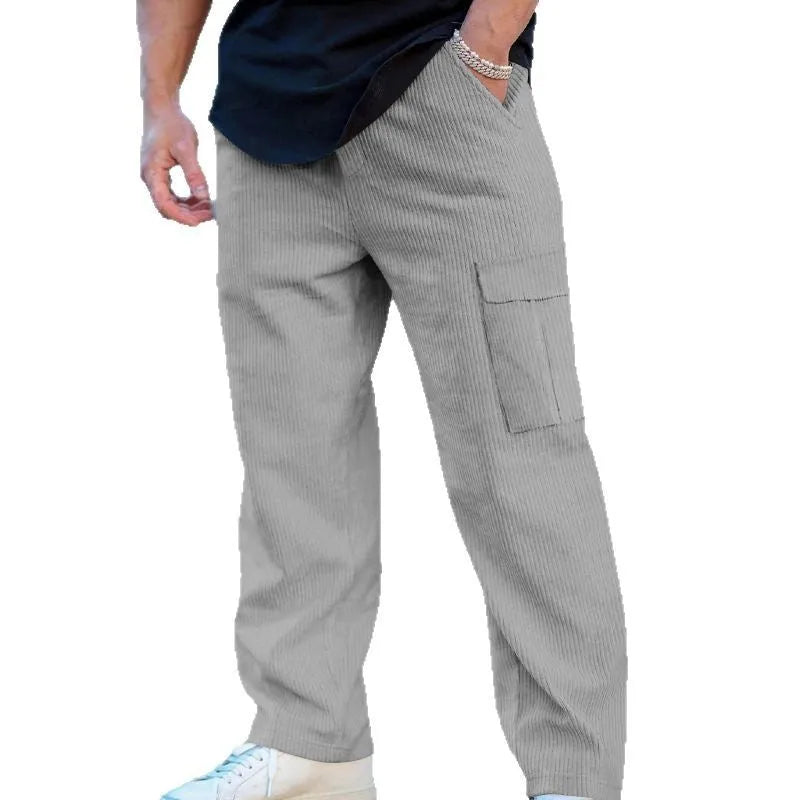 Men's navy blue corduroy cargo trousers with a straight loose leg and a drawstring waist, laid flat.