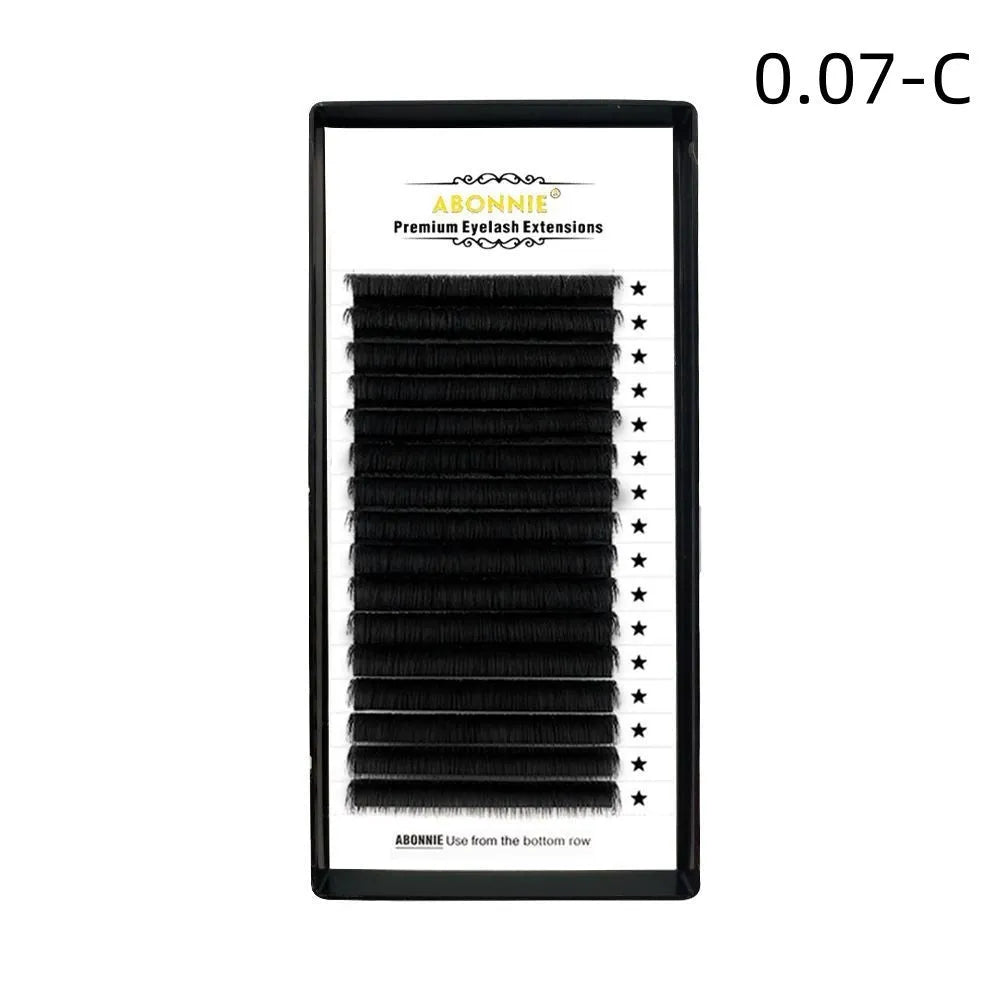 Close-up of dense 16-row matte mink hair false eyelashes on a clear band, showing natural finish.