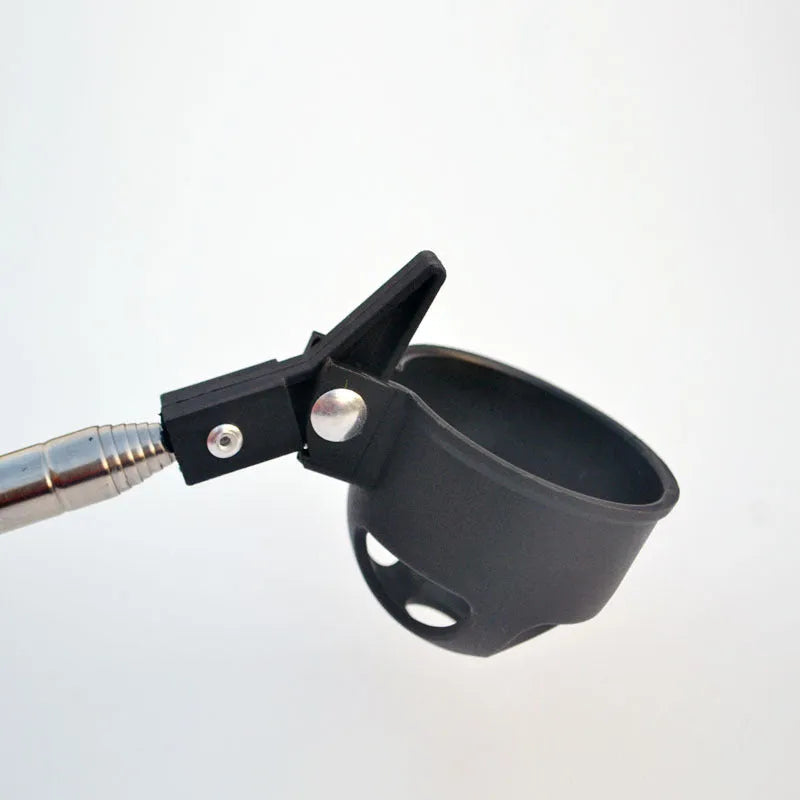 Black stainless steel retractable golf ball retriever with plastic head on golf course