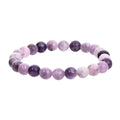 Purple natural stone elastic bead bracelet with geometric shapes in various sizes.