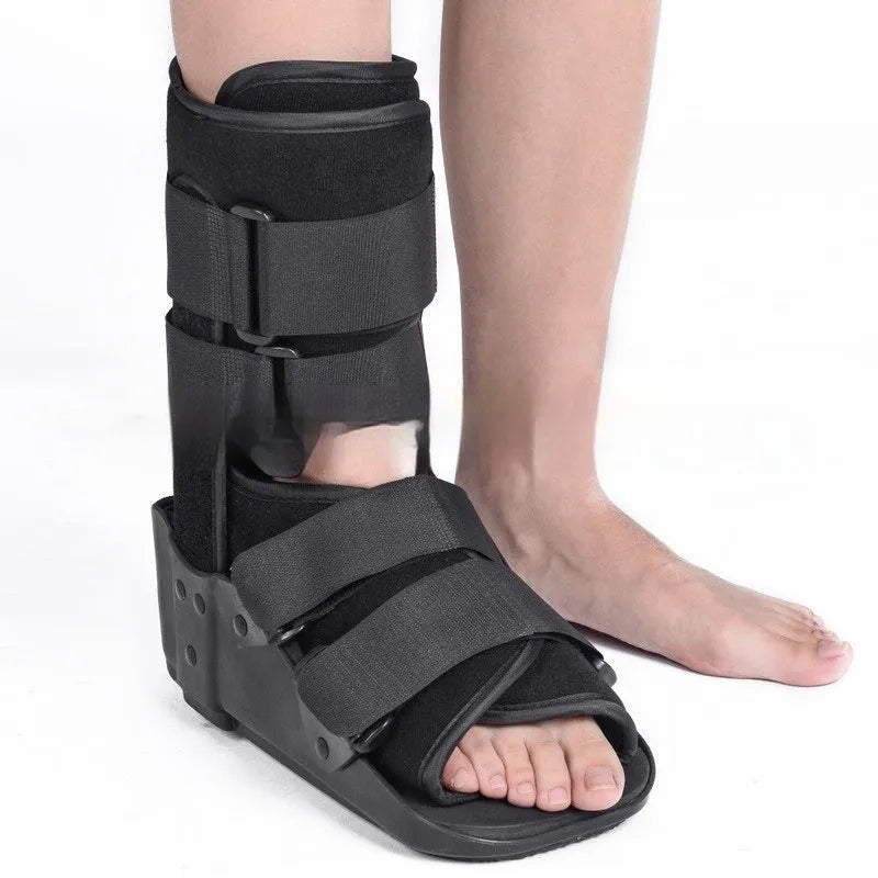 Black adjustable Achilles tendon rehabilitation boot with aluminium struts, shown on a foot.