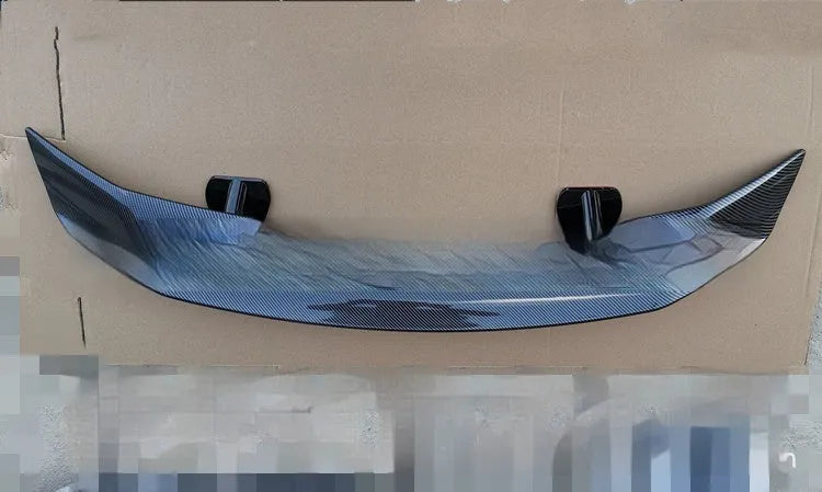 Universal punch-free car spoiler tail wing in ABS plastic on a vehicle.