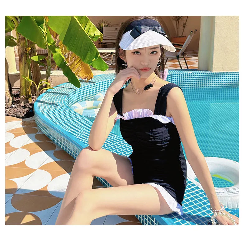 Women's solid colour one-piece swimsuit with suspender straps in pink, green or black options