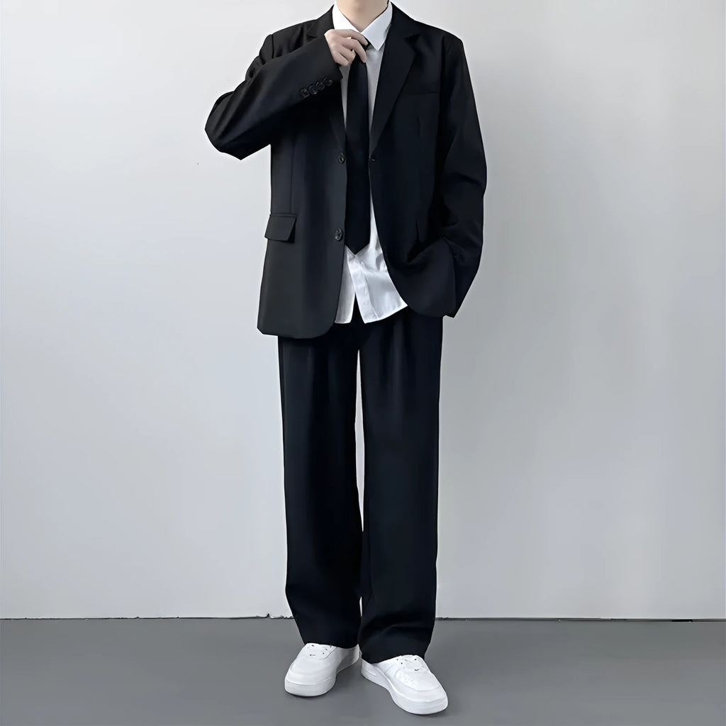 Plus size men's grey suit jacket and trousers set with white shirt and blue tie on a hanger