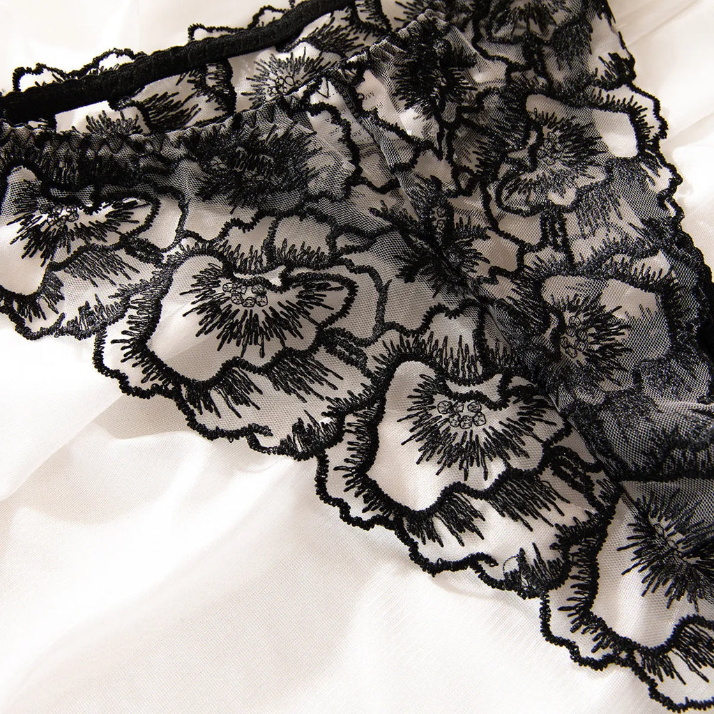 Black women's embroidered lace underwear with transparent sections and steel ring detail