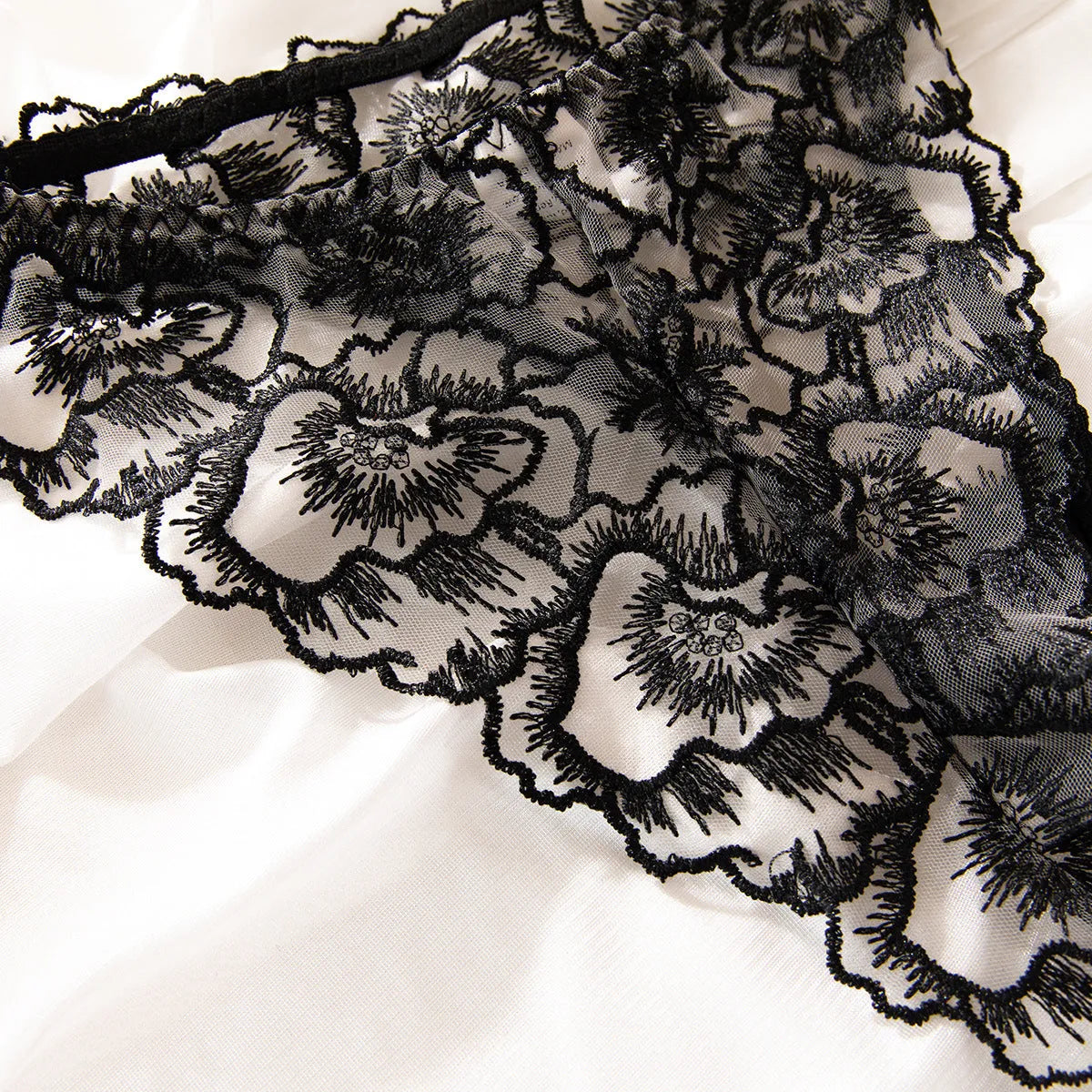 Black women's embroidered lace underwear with transparent sections and steel ring detail