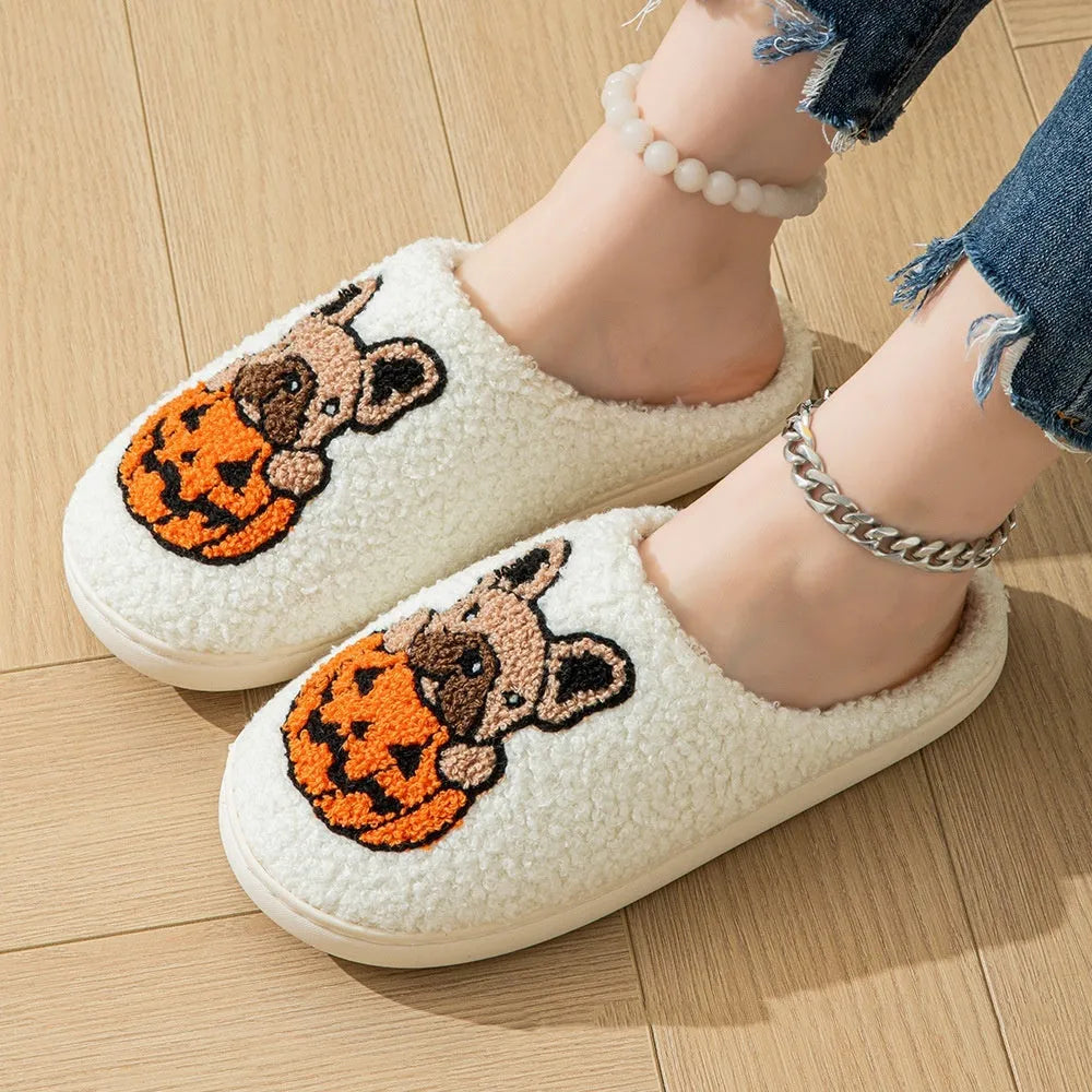 Black and white Halloween plush slippers with pumpkin design and non-slip rubber soles