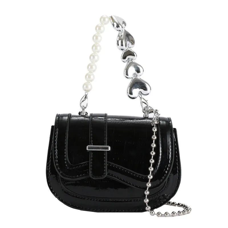 Laser pearl finish mini tote saddle crossbody bag in a choice of colours, shown with a single strap and structured square shape.