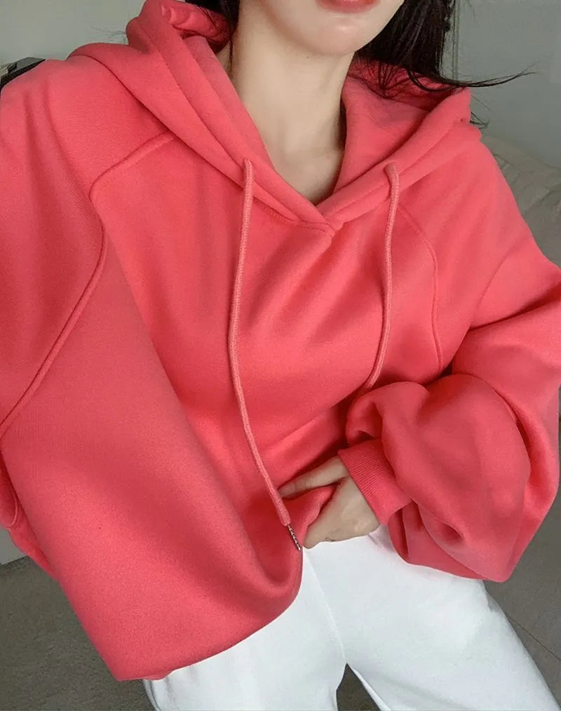 Women's loose watermelon red mulberry silk hooded pullover sweater on a hanger.