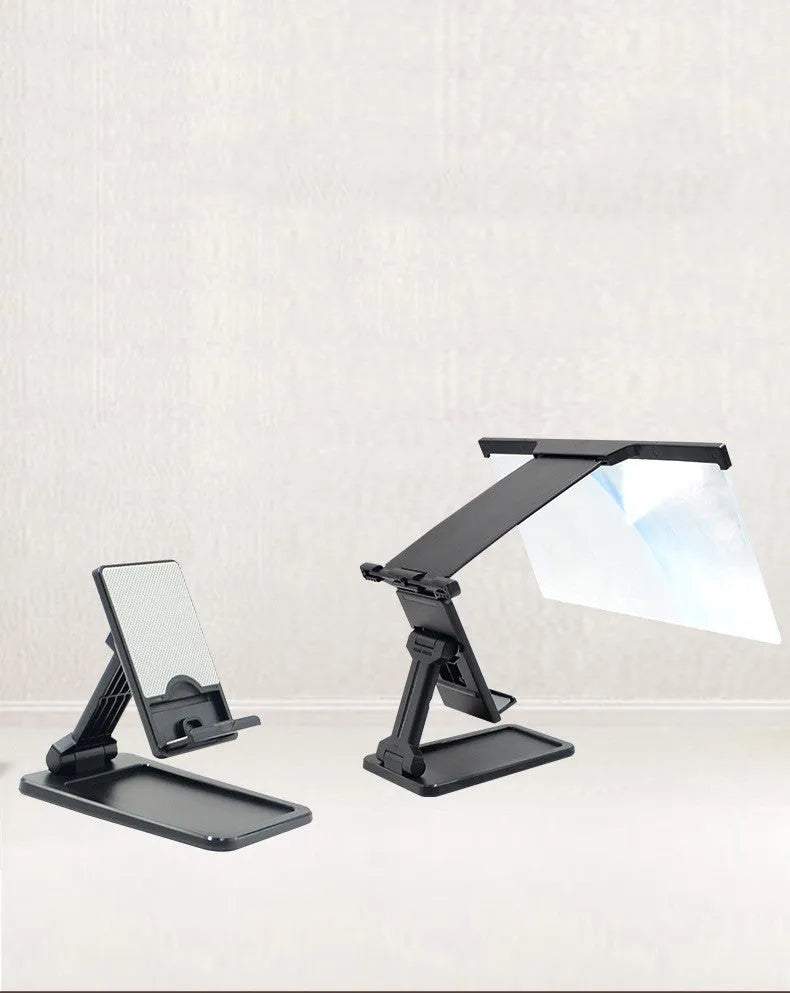 Black foldable mobile phone screen magnifier with a detachable phone holder on a desk.