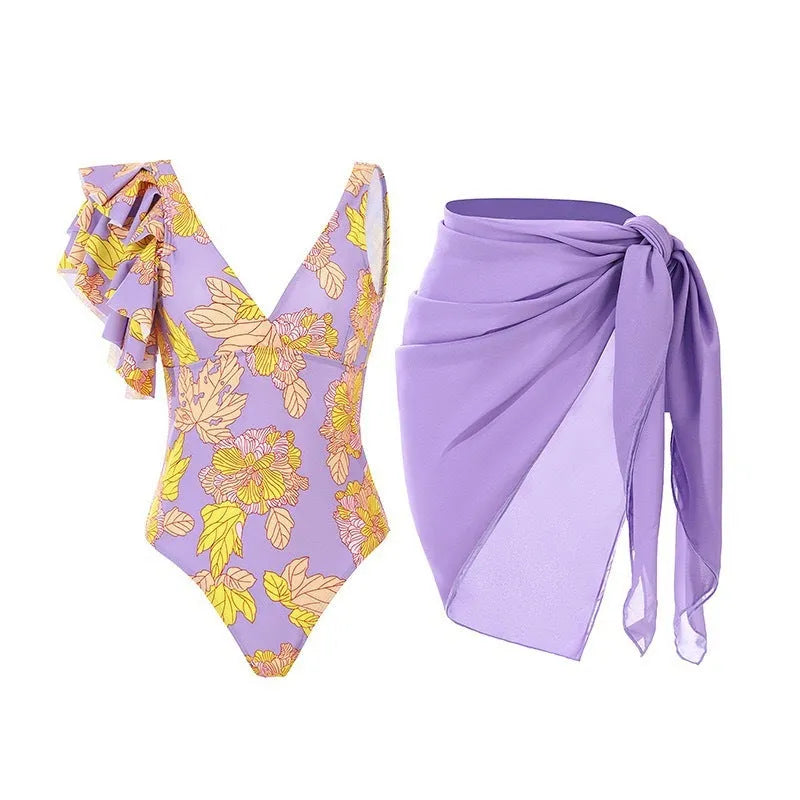 Solid colour women's one-piece swimsuit with thin spaghetti straps and a removable wrap skirt.