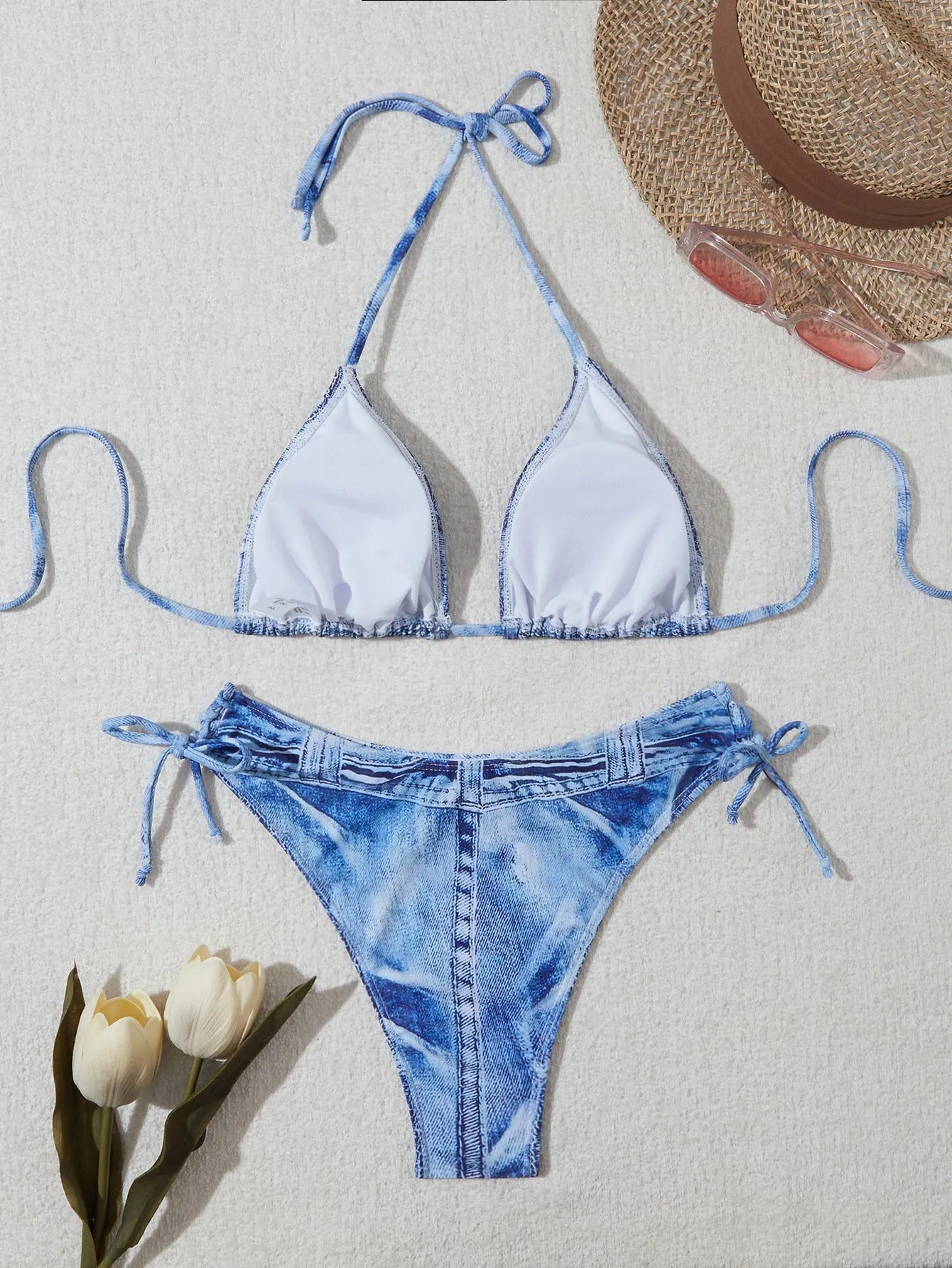 Denim blue printed women's bikini set with strap design, shown on a model.