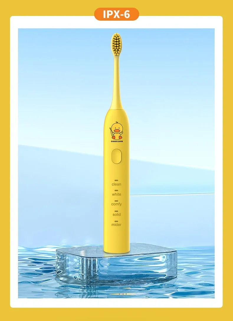 Yellow rechargeable electric toothbrush with small duck design, soft bristles, and USB charging port.