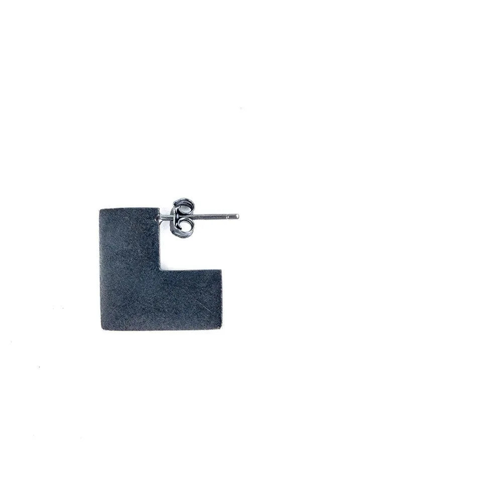 Close-up of a pair of oxidation black geometric square stud earrings made from 925 sterling silver.