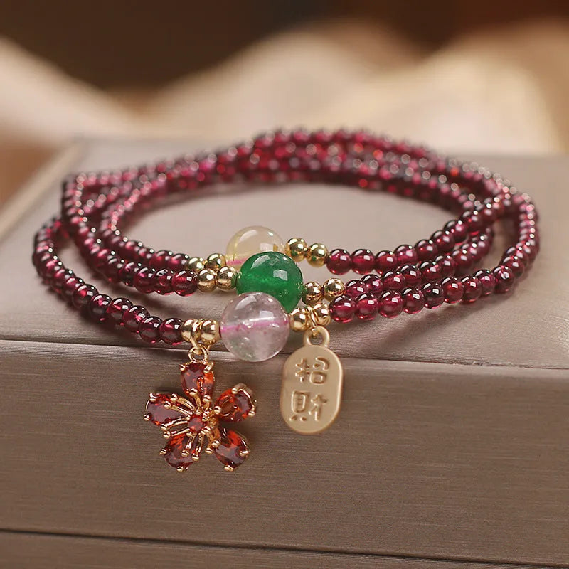 Women's simple bracelet made of red crystal with sequin accents on a wrist.