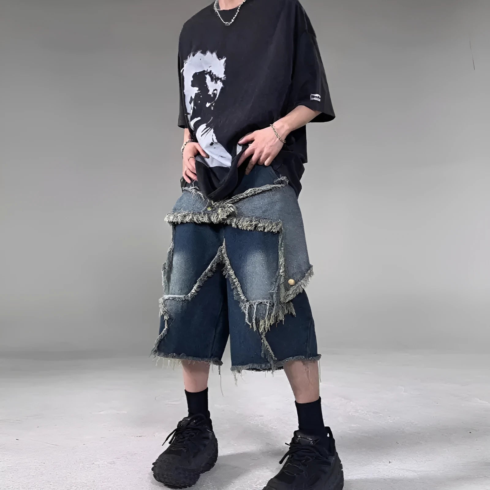 Blue men's denim shorts with a loose fit, frayed hem, and an embroidered five-pointed star on the leg.