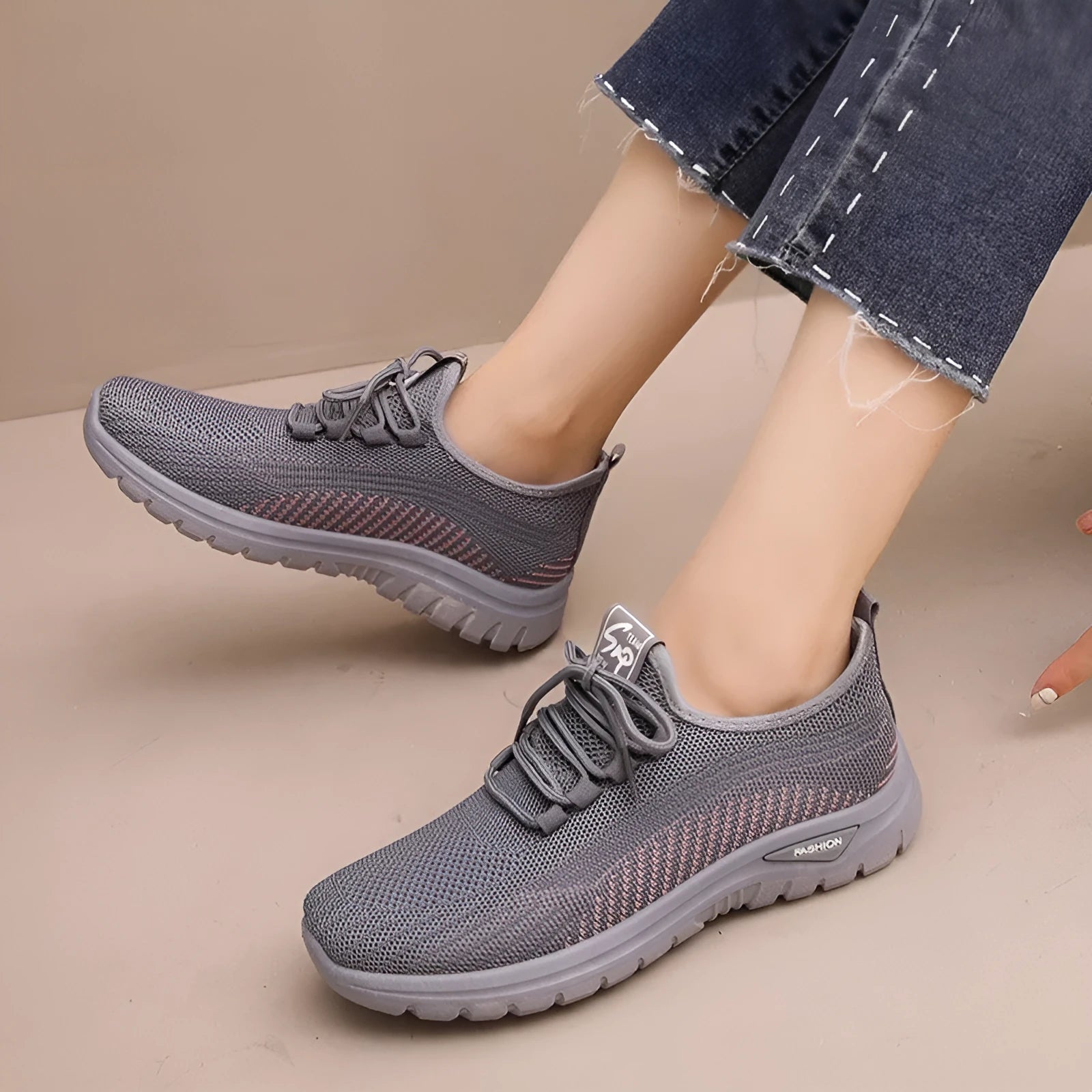 Women's black mesh sneakers with cross straps, round toe, and lace-up front on a rubber sole.