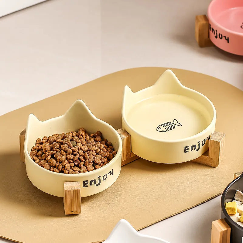 Porcelain cat bowl with wooden anti-tumble frame in pink with cat paw design