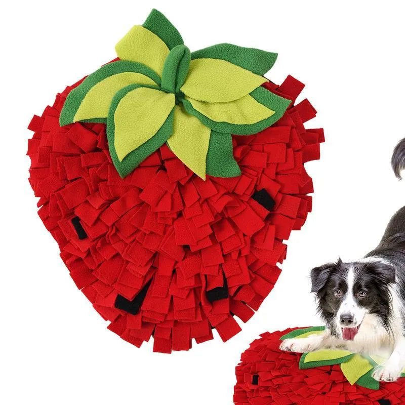 Red and green strawberry-shaped interactive slow feeder mat for pets on a floor.