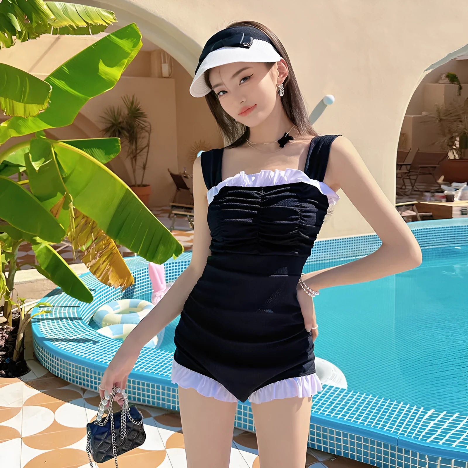 Women's solid colour one-piece swimsuit with suspender straps in pink, green or black options