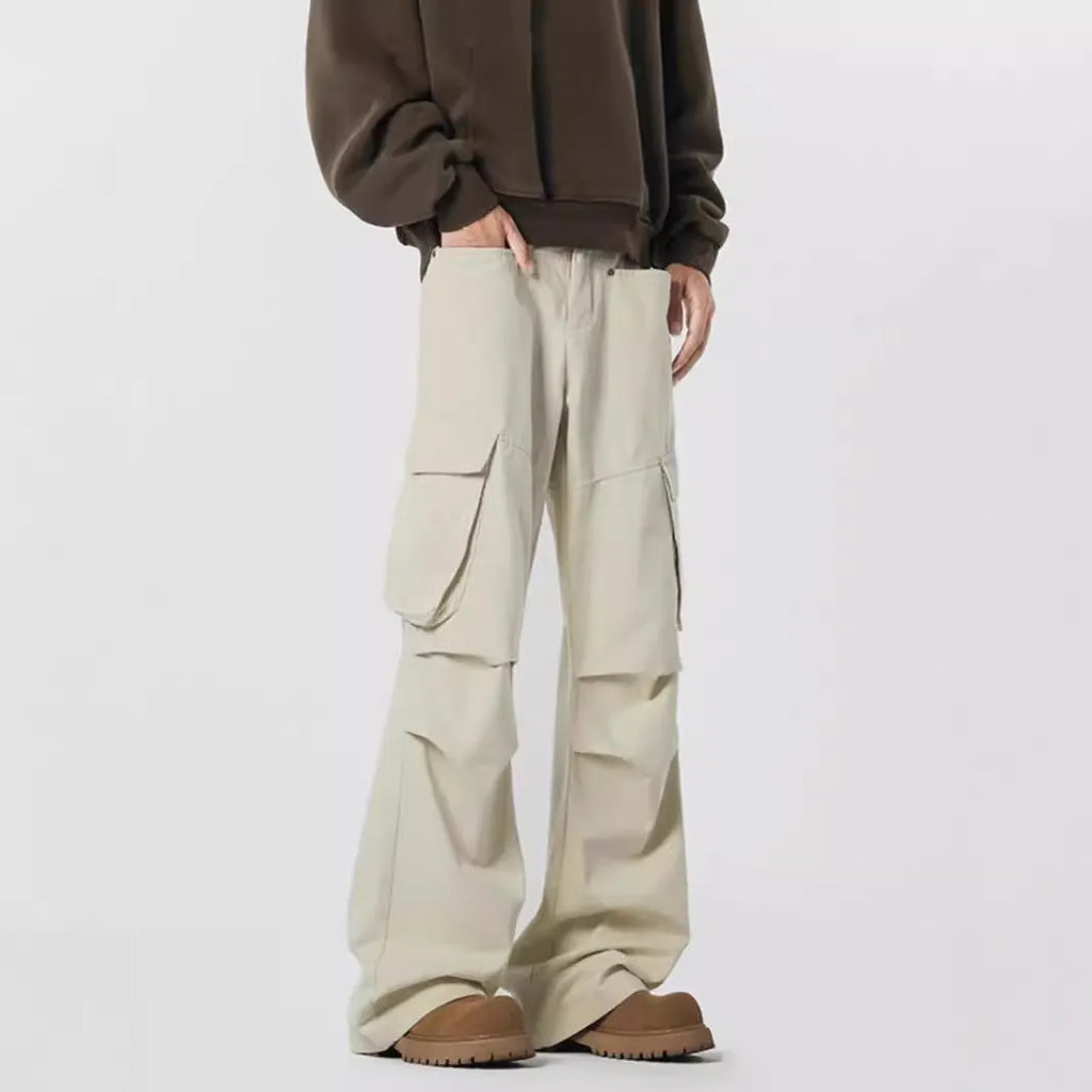 Man wearing black retro high-waist straight-leg casual trousers with a buttoned flap detail.