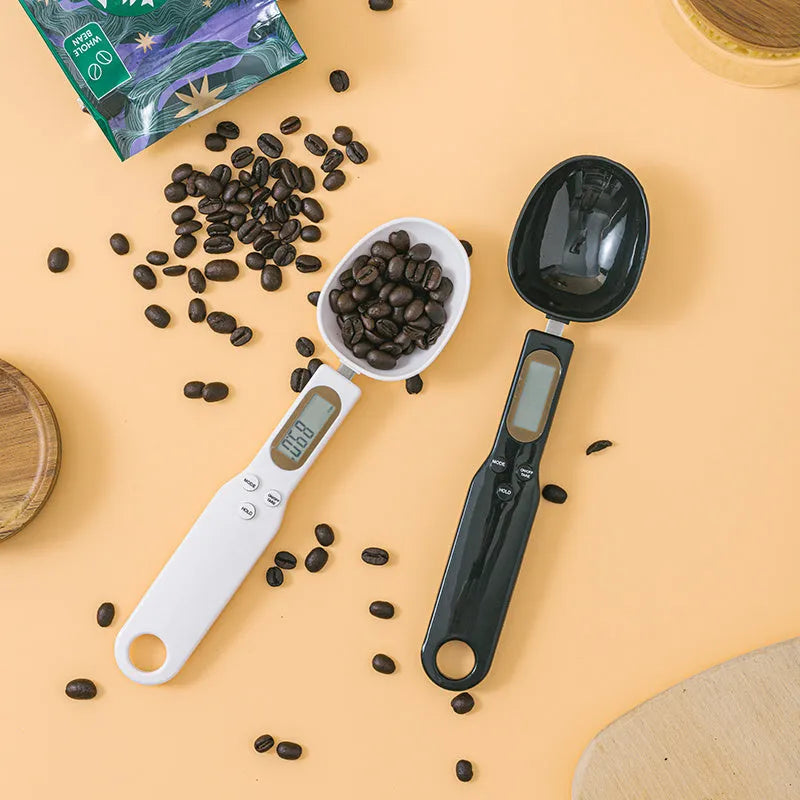 White digital kitchen scale with LCD display and spoon-shaped weighing surface for precise ingredient measurements