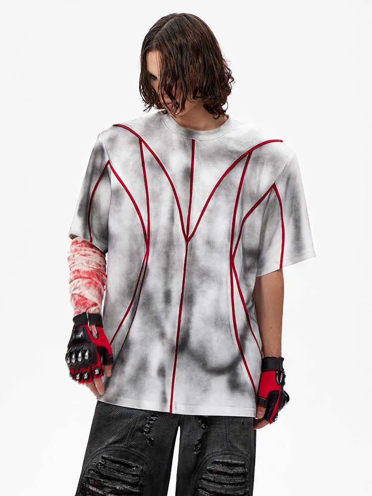 Short sleeve T-shirt with padded shoulders and three-dimensional line patchwork detail on a round neck