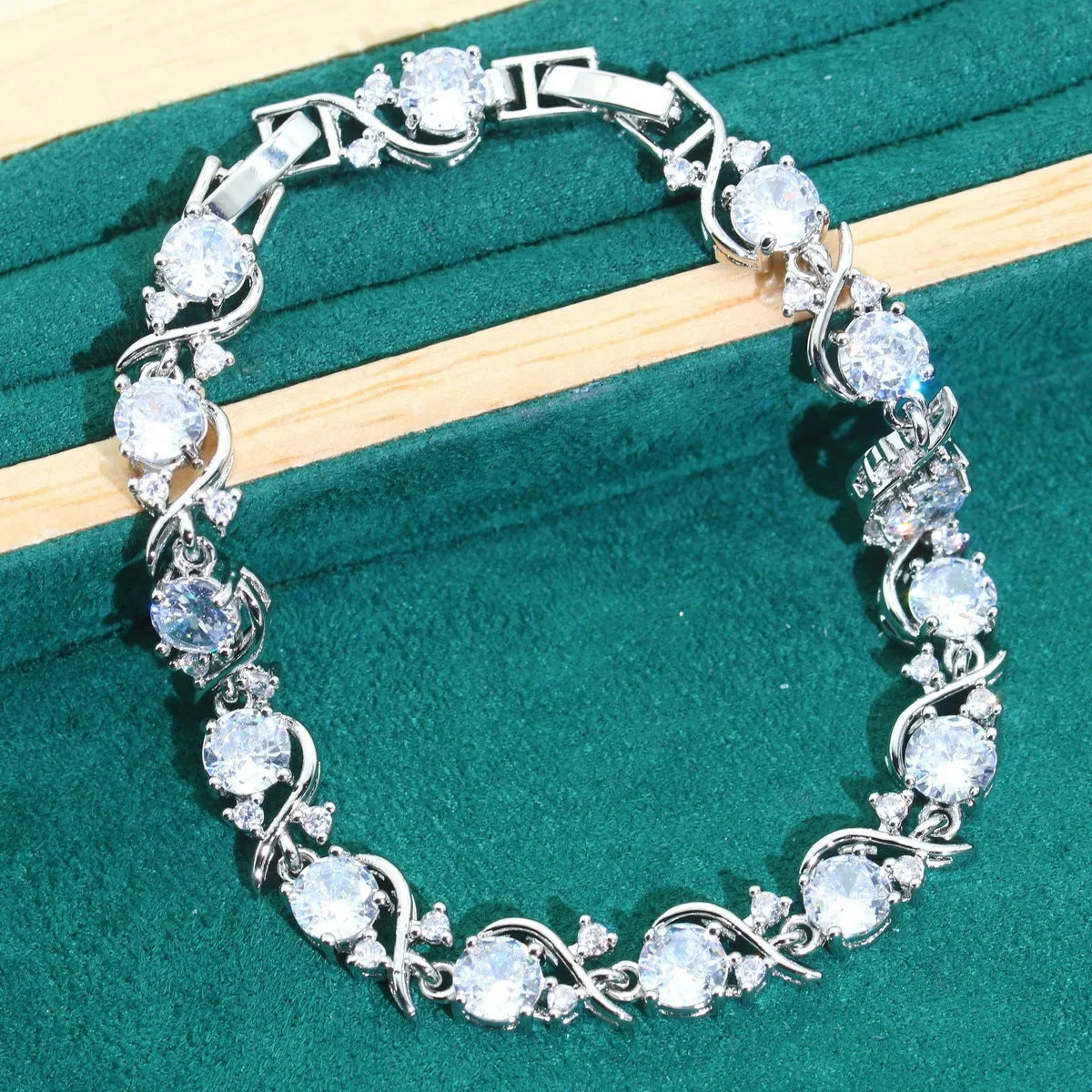 Bridal four-piece jewellery set showing necklace, earrings, ring and bracelet with water wave chain design